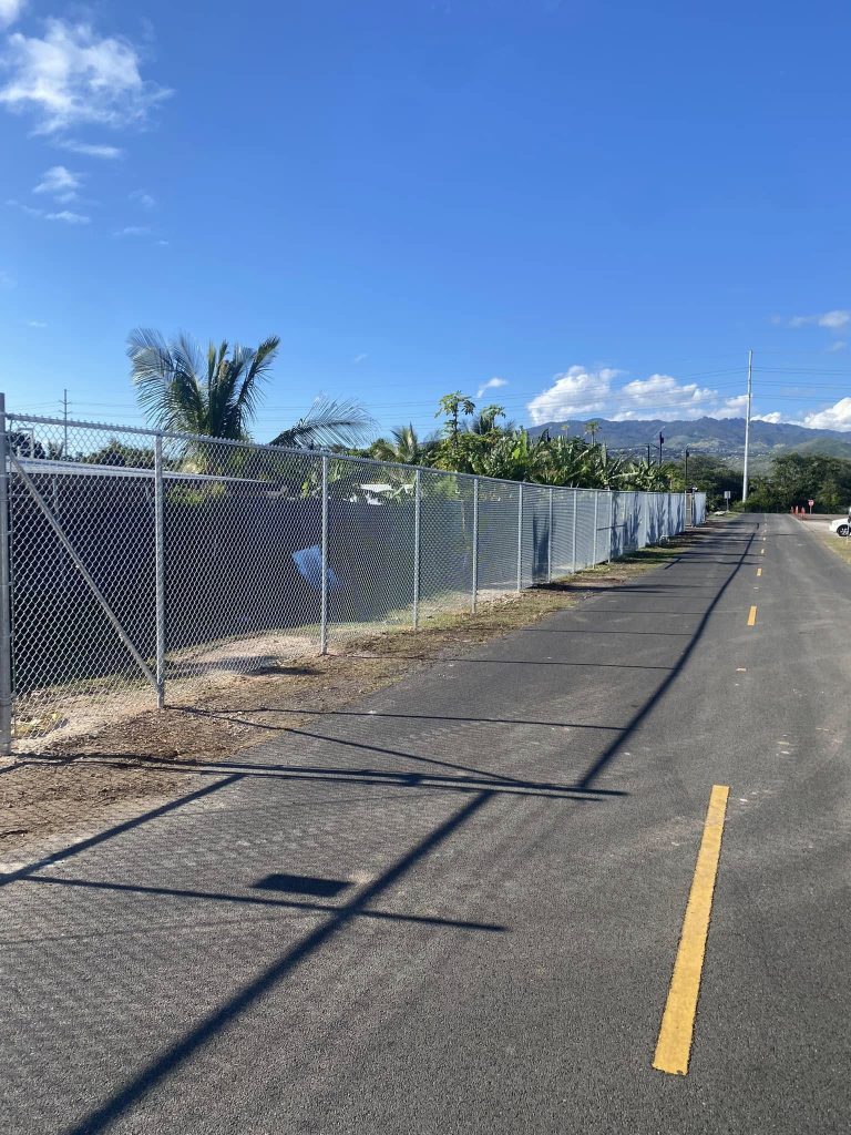 Completed straight run of new chain-link fence installed in Kapolei.