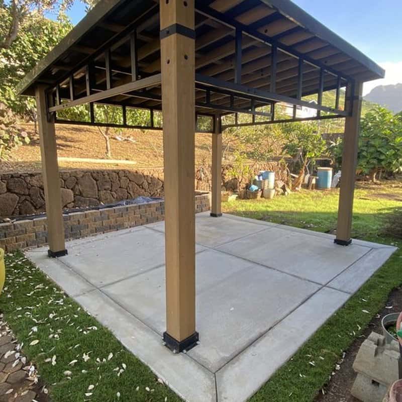 Completed backyard gazebo with fresh concrete pad and clean landscaping in Oahu.