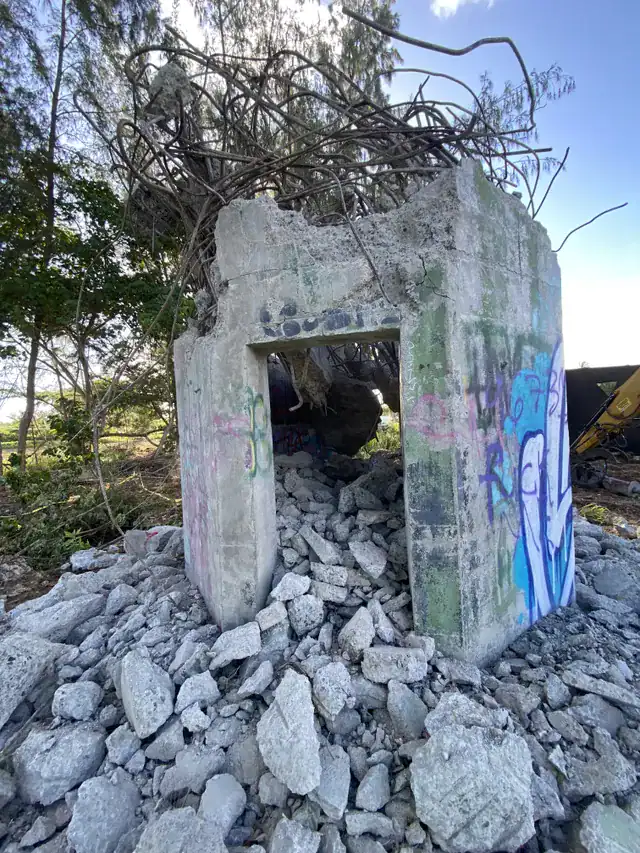 Alt text: Standing concrete structure at the Kahuku site before demolition.