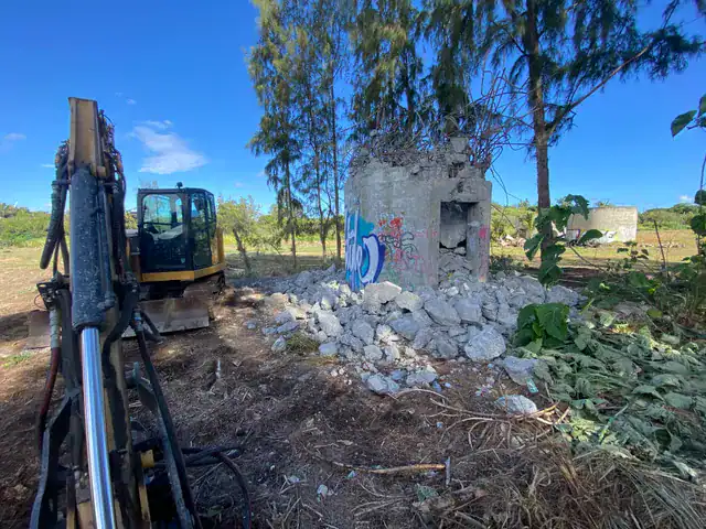 Old concrete structure and rubble at the Kahuku demolition site.