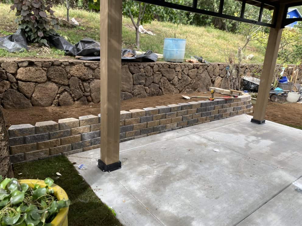 Retaining wall and graded yard area prepared for landscaping.