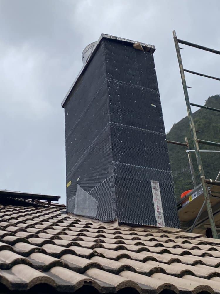 Chimney wrapped in waterproofing paper before metal lath installation