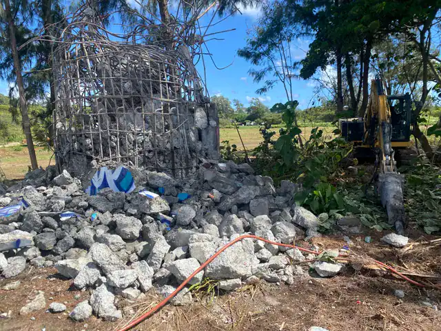 Concrete rubble piled after demolition of old sugar mill structures.