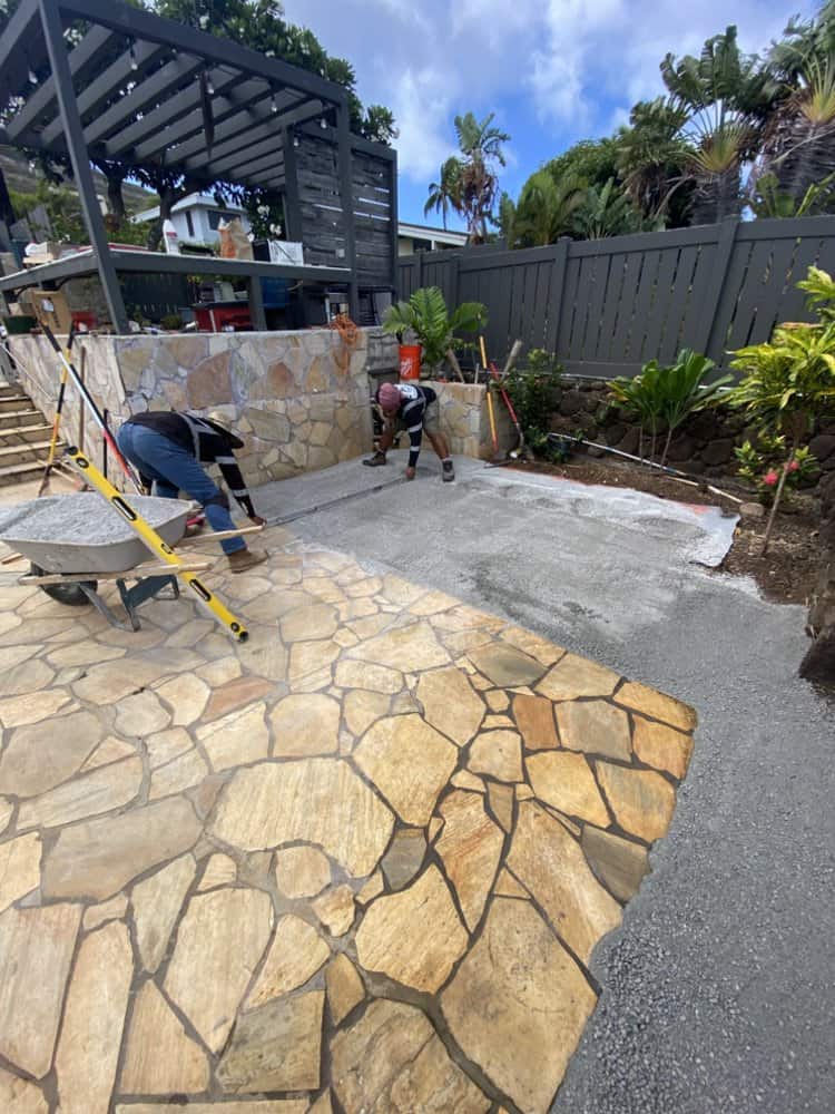 Screeding the base material to create a smooth, level surface before laying turf.