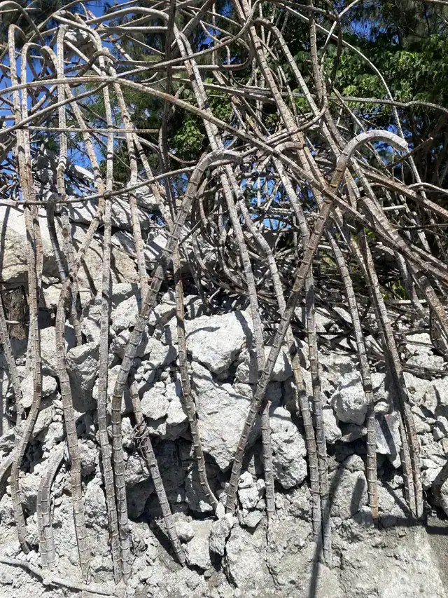 Demolition exposing rebar inside old concrete during breakup.