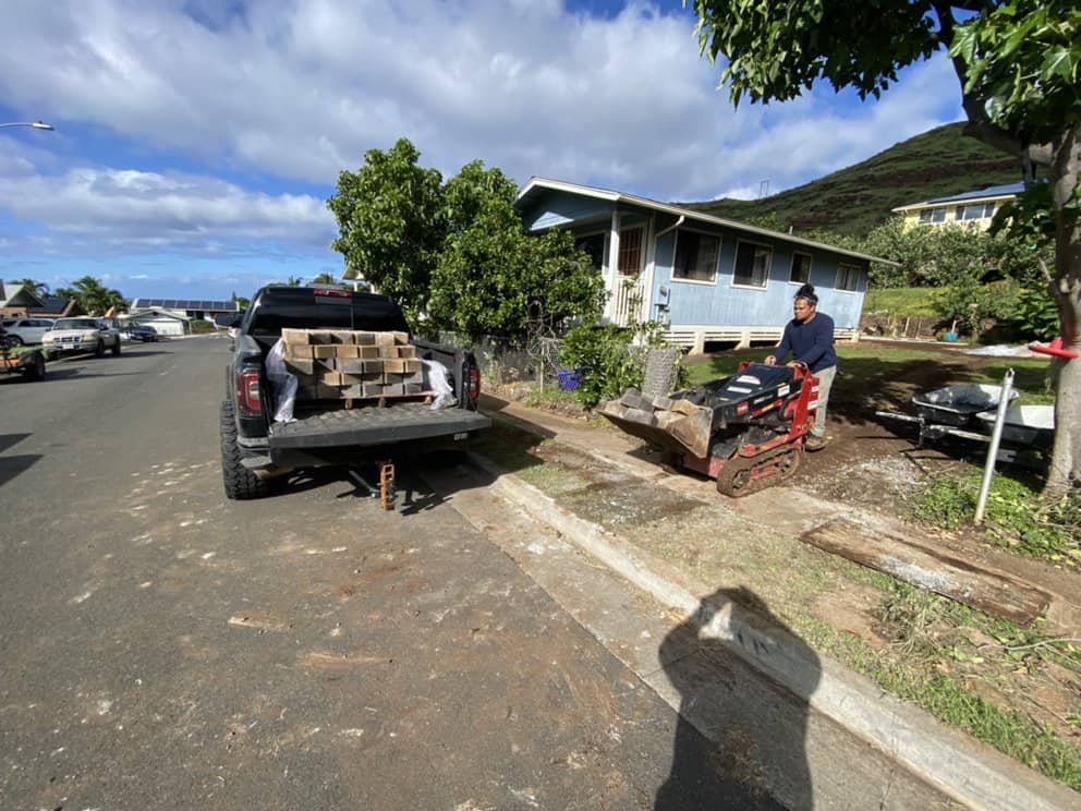 Retaining wall blocks delivered and staged before installation.