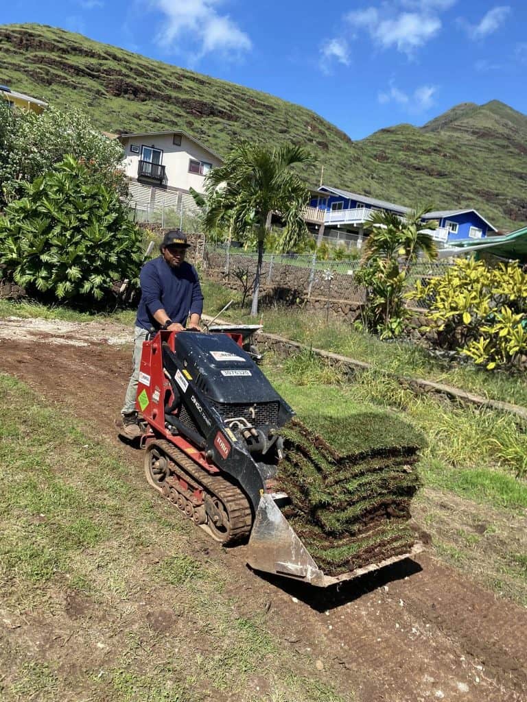 Fresh sod delivered for yard preparation after completing the retaining wall installation.