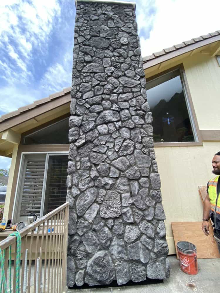 Close-up view of completed blue rock veneer chimney with clean mortar joints