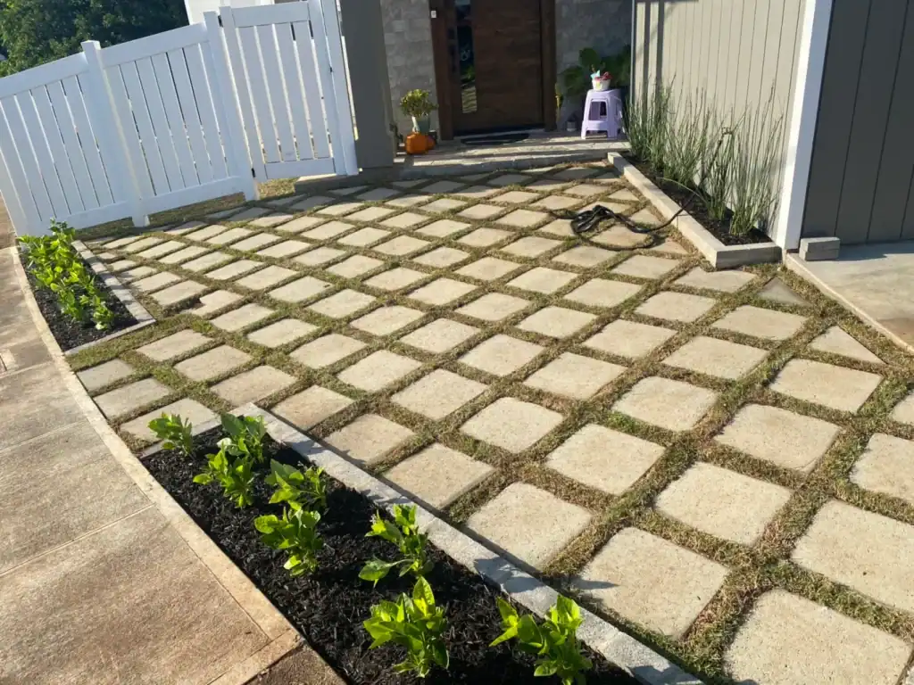 front yard grid-style paver walkway with new planting beds and clean modern entrance
