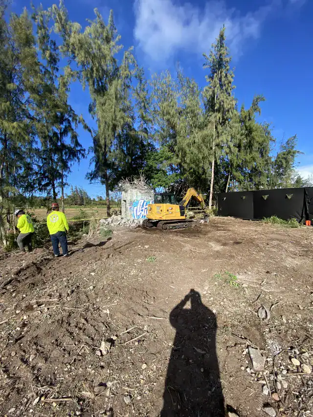 Cleared demolition site in Kahuku after concrete removal and land grading.