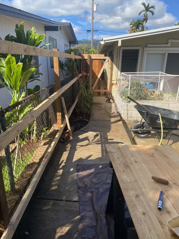 site preparation during fence replacement showing removed boards and framing setup