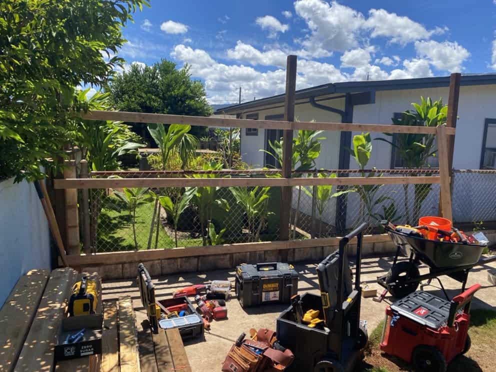 mid-construction view of fence framing and partial board installation