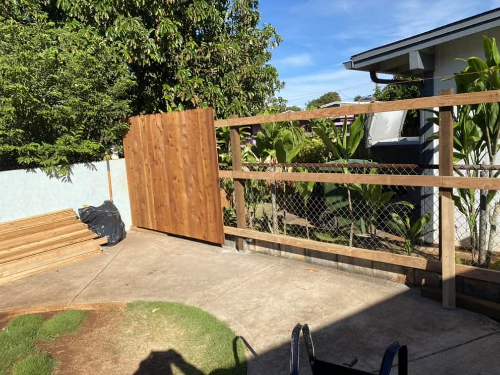 early installation stage with the first fence boards attached to new framing