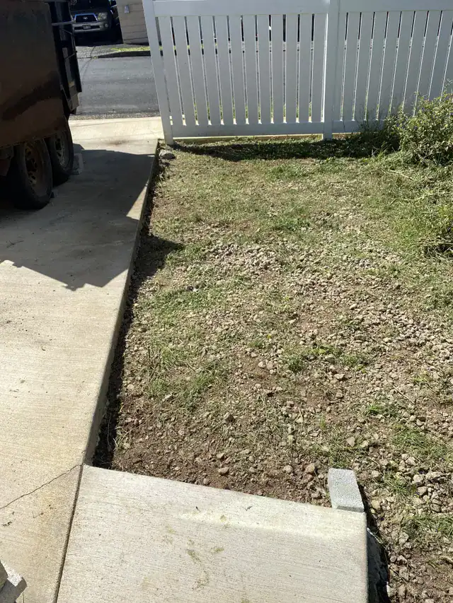 Bare planting bed before concrete paver and landscaping work